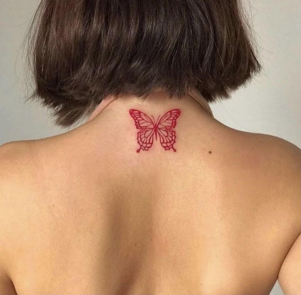 Red butterfly tattoo on back of neck