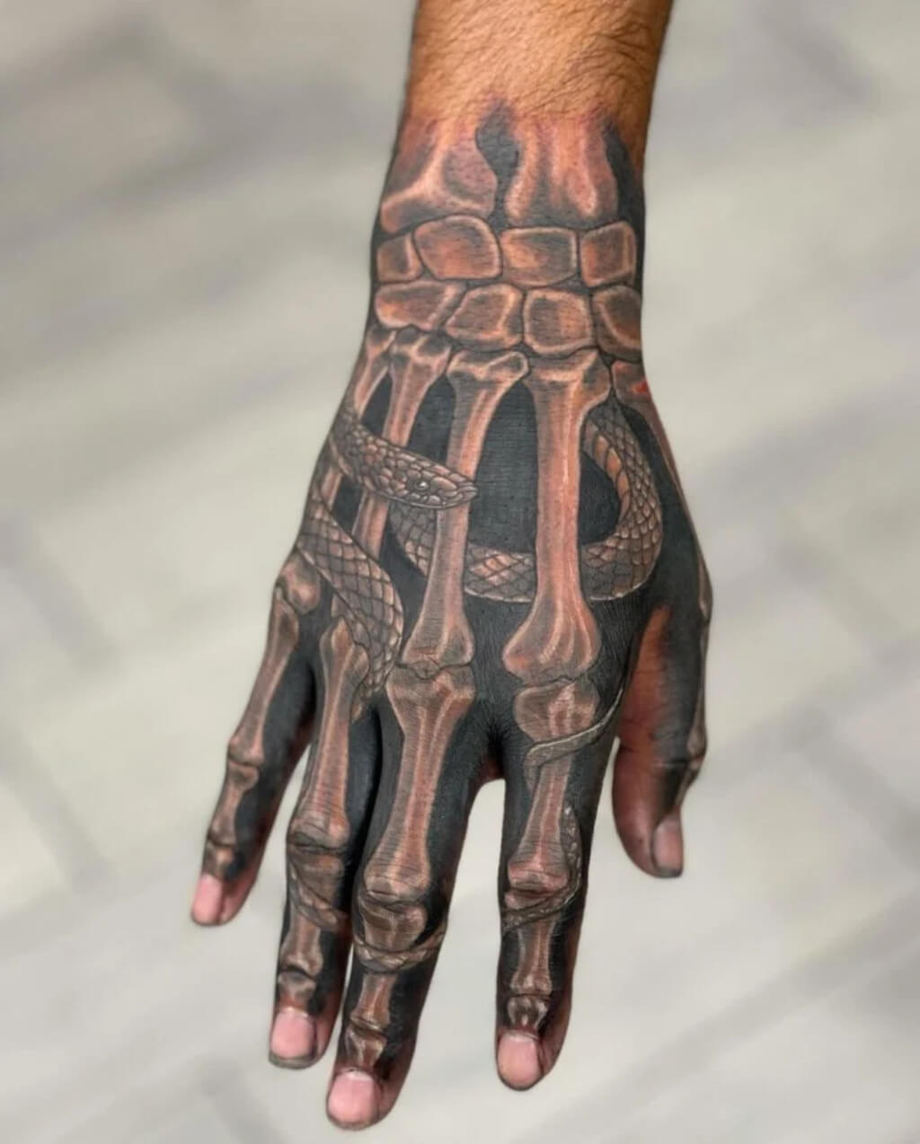 Bone and Snake Hand Tattoo